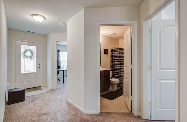22418 Threefold Ridge Dr, Hockley, TX 77447 - entryway featuring light colored carpet and light tile patterned floors