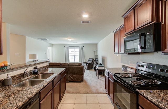 22418 Threefold Ridge Dr, Hockley, TX 77447 - kitchen featuring black appliances, light colored carpet, dark stone counters, and open floor plan