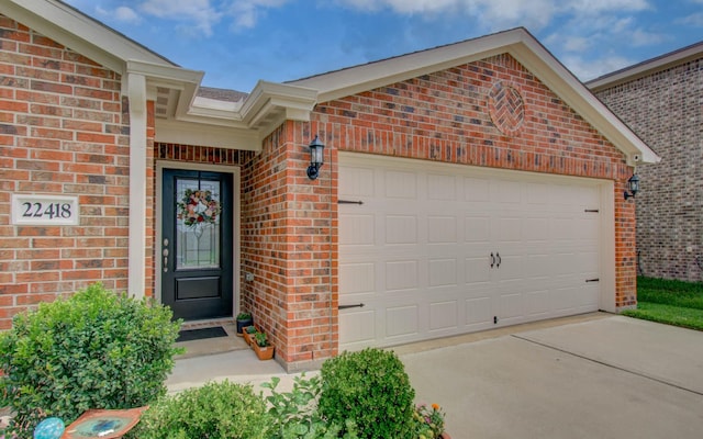 22418 Threefold Ridge Dr, Hockley, TX 77447 - entrance to property featuring brick siding, an attached garage, and driveway
