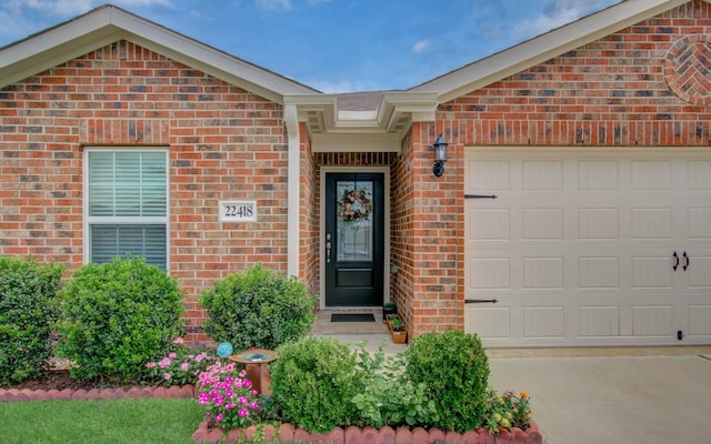 22418 Threefold Ridge Dr, Hockley, TX 77447 - property entrance featuring brick siding, an attached garage, and concrete driveway