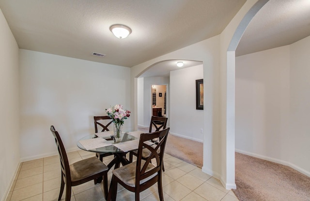 22418 Threefold Ridge Dr, Hockley, TX 77447 - dining room featuring arched walkways and light tile patterned floors