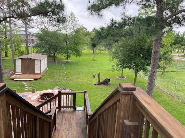 1025 14th St, Dickinson, TX 77539 - fenced backyard featuring an outdoor fire pit, a storage shed, and a wooden deck