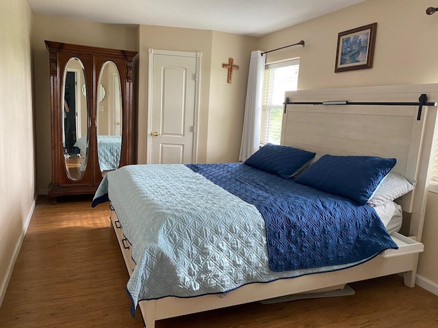 1025 14th St, Dickinson, TX 77539 - bedroom with baseboards and wood finished floors