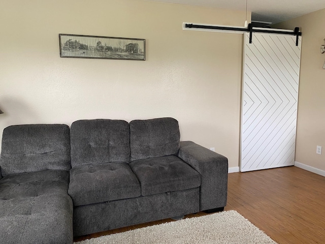 1025 14th St, Dickinson, TX 77539 - living room featuring a barn door and wood finished floors