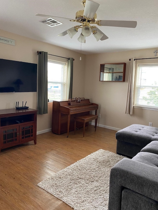 1025 14th St, Dickinson, TX 77539 - living room with light wood-style flooring, plenty of natural light, and a ceiling fan