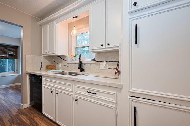 5130 Porter Ridge Dr, Houston, TX 77053 - kitchen with black dishwasher, white cabinetry, backsplash, dark wood-style flooring, and light countertops
