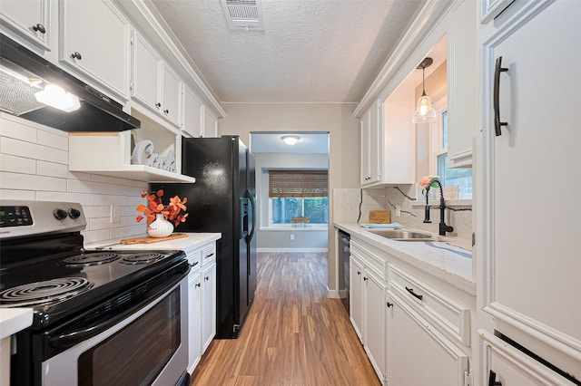 5130 Porter Ridge Dr, Houston, TX 77053 - kitchen with electric stove, under cabinet range hood, white fridge, white cabinets, and a textured ceiling