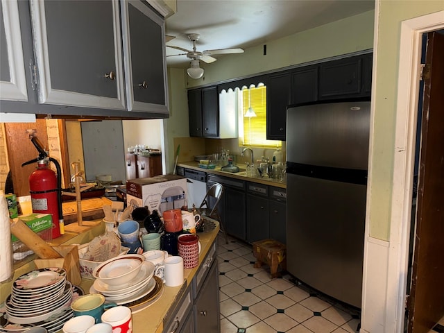 1151 Creekmont Dr, Houston, TX 77091 - kitchen with freestanding refrigerator, a ceiling fan, and dark cabinetry