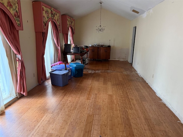 1151 Creekmont Dr, Houston, TX 77091 - dining room featuring a chandelier, light wood-type flooring, healthy amount of natural light, and lofted ceiling