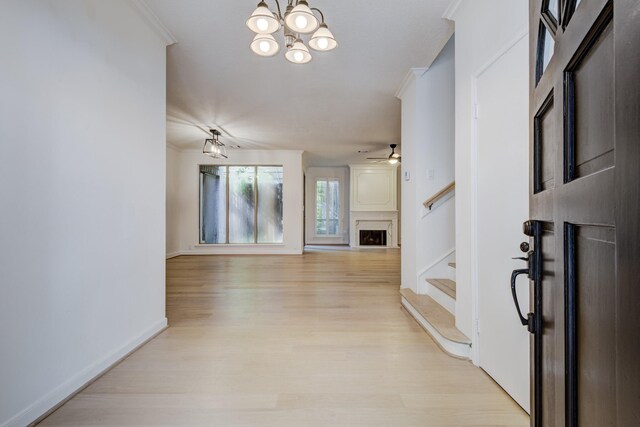 2308 Nantucket Dr Unit B, Houston, TX 77057 - entryway featuring stairway, light wood finished floors, a chandelier, ceiling fan, and a fireplace