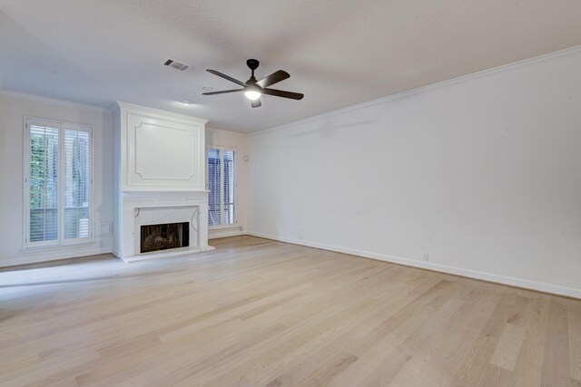 2308 Nantucket Dr Unit B, Houston, TX 77057 - unfurnished living room with crown molding, light wood finished floors, a fireplace, and a ceiling fan