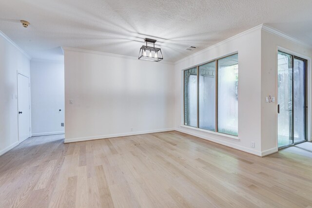 2308 Nantucket Dr Unit B, Houston, TX 77057 - spare room with crown molding, light wood-style flooring, a smoke detector, and a textured ceiling