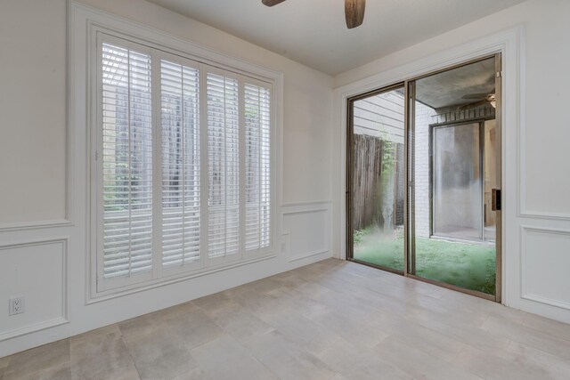 2308 Nantucket Dr Unit B, Houston, TX 77057 - unfurnished room with a ceiling fan, a decorative wall, and a wainscoted wall