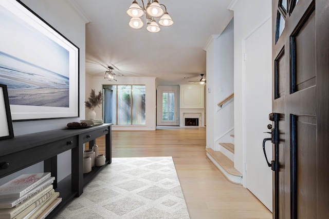 2308 Nantucket Dr Unit B, Houston, TX 77057 - foyer with stairs, light wood finished floors, a chandelier, a ceiling fan, and a fireplace