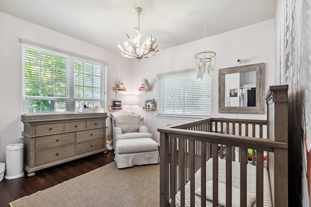 13518 Via Chianti Ln, Cypress, TX 77429 - bedroom with a chandelier, wood finished floors, and a nursery area
