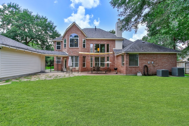 13518 Via Chianti Ln, Cypress, TX 77429 - back of house featuring brick siding, a patio, a chimney, and roof with shingles