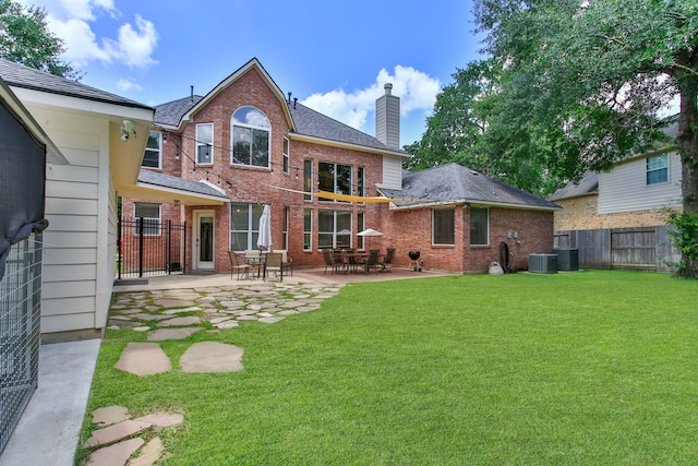 13518 Via Chianti Ln, Cypress, TX 77429 - rear view of house featuring a chimney, brick siding, a fenced backyard, and a patio area