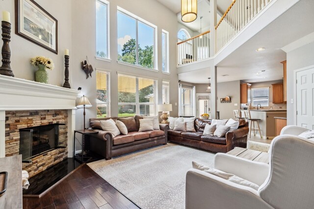 13518 Via Chianti Ln, Cypress, TX 77429 - living room with a stone fireplace, dark wood-type flooring, and a high ceiling
