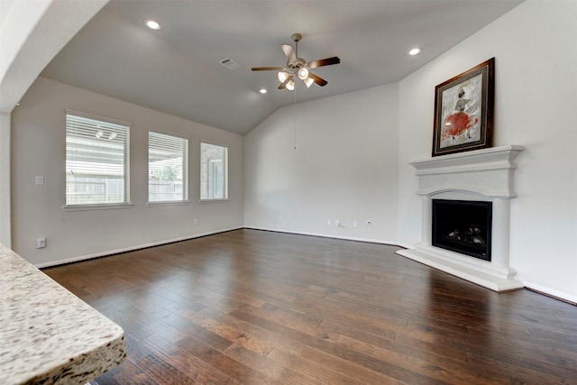 24014 Bluestem Ridge Ct, Katy, TX 77493 - unfurnished living room featuring a ceiling fan, dark wood-style floors, a fireplace with raised hearth, recessed lighting, and vaulted ceiling