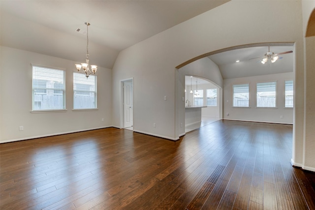 24014 Bluestem Ridge Ct, Katy, TX 77493 - empty room with vaulted ceiling, a chandelier, a ceiling fan, dark wood-style flooring, and arched walkways