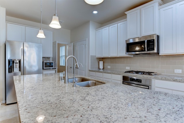 24014 Bluestem Ridge Ct, Katy, TX 77493 - kitchen featuring stainless steel appliances, light stone countertops, backsplash, white cabinets, and recessed lighting