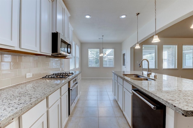 24014 Bluestem Ridge Ct, Katy, TX 77493 - kitchen featuring appliances with stainless steel finishes, backsplash, recessed lighting, white cabinets, and light stone counters