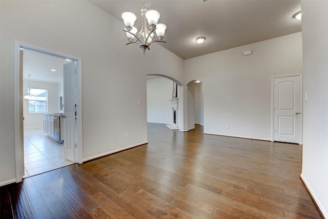 24014 Bluestem Ridge Ct, Katy, TX 77493 - empty room with arched walkways, wood finished floors, and a chandelier