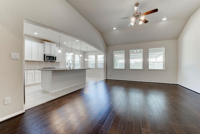24014 Bluestem Ridge Ct, Katy, TX 77493 - unfurnished living room featuring vaulted ceiling, a ceiling fan, wood-type flooring, and recessed lighting