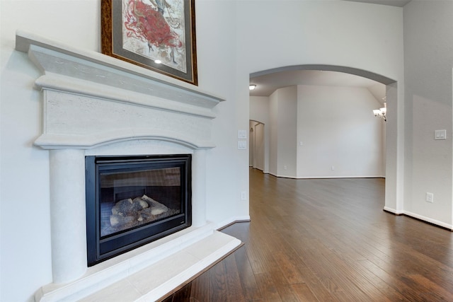 24014 Bluestem Ridge Ct, Katy, TX 77493 - detailed view of arched walkways, wood finished floors, and a glass covered fireplace