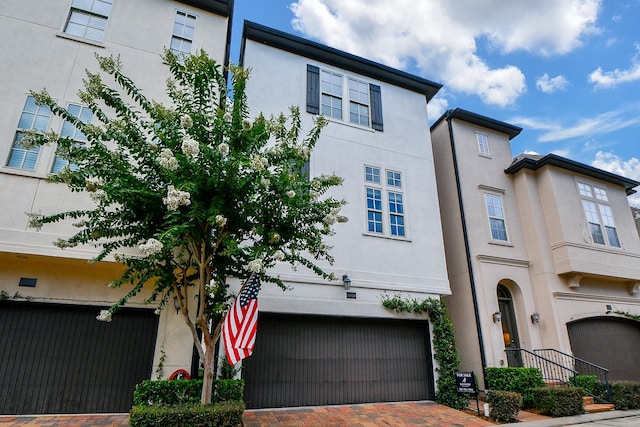 10924 Wrenwood Park, Houston, TX 77043 - townhome / multi-family property featuring an attached garage, decorative driveway, and stucco siding