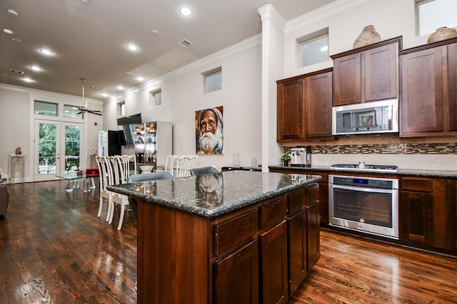 10924 Wrenwood Park, Houston, TX 77043 - kitchen featuring stainless steel appliances, ornamental molding, dark wood-type flooring, a kitchen island, and recessed lighting