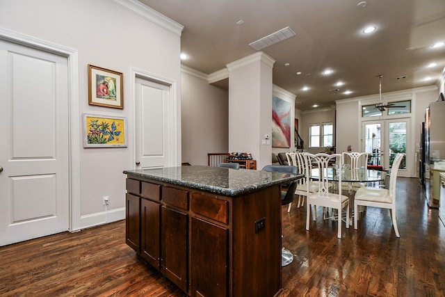 10924 Wrenwood Park, Houston, TX 77043 - kitchen featuring ornamental molding, dark wood-type flooring, a kitchen island, dark brown cabinetry, and freestanding refrigerator