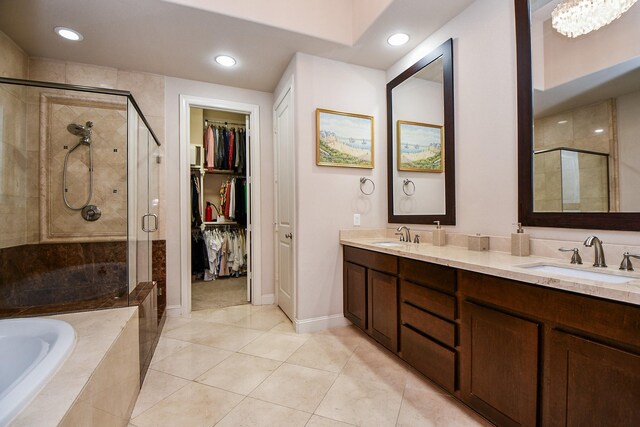 10924 Wrenwood Park, Houston, TX 77043 - full bathroom featuring a stall shower, a bath, double vanity, a walk in closet, and recessed lighting