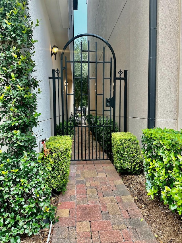 10924 Wrenwood Park, Houston, TX 77043 - view of exterior entry with a gate and stucco siding