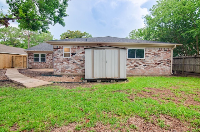 12706 Westleigh Dr, Houston, TX 77077 - rear view of property with a fenced backyard, brick siding, a shed, a shingled roof, and a patio area