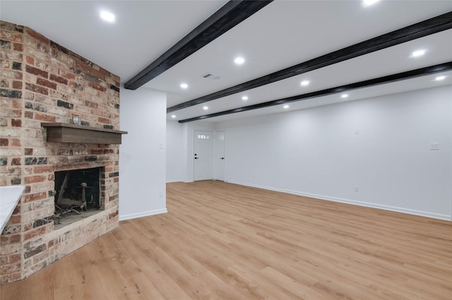12706 Westleigh Dr, Houston, TX 77077 - unfurnished living room featuring beam ceiling, light wood finished floors, recessed lighting, and a fireplace