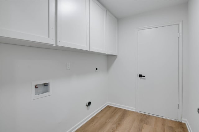 12706 Westleigh Dr, Houston, TX 77077 - laundry room featuring cabinet space, washer hookup, hookup for an electric dryer, and light wood-style flooring