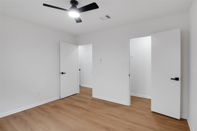 12706 Westleigh Dr, Houston, TX 77077 - unfurnished bedroom with light wood-type flooring, a walk in closet, and ceiling fan