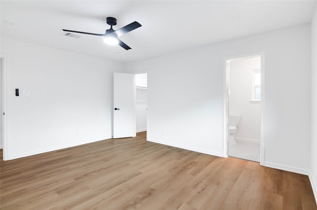 12706 Westleigh Dr, Houston, TX 77077 - unfurnished bedroom featuring light wood finished floors, a spacious closet, connected bathroom, ceiling fan, and a closet