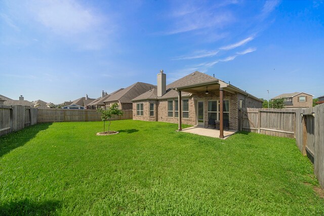 3822 Moreland Branch Ln, Katy, TX 77493 - back of house featuring a chimney, a patio, brick siding, and a fenced backyard