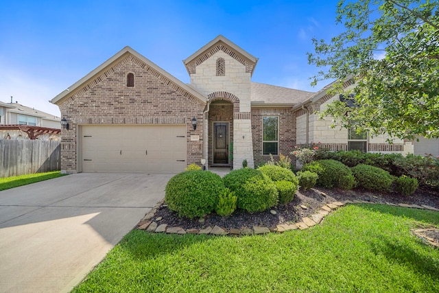 3822 Moreland Branch Ln, Katy, TX 77493 - french country inspired facade with a garage, driveway, stone siding, and brick siding