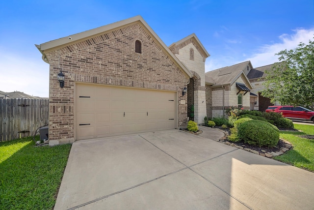 3822 Moreland Branch Ln, Katy, TX 77493 - french country style house with brick siding, concrete driveway, and an attached garage