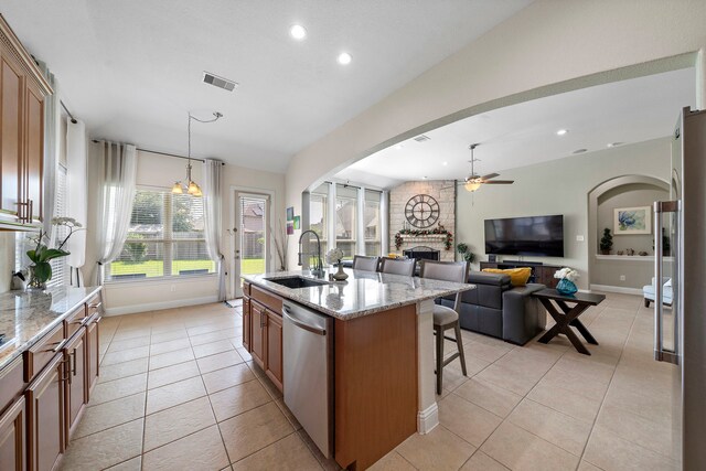 3822 Moreland Branch Ln, Katy, TX 77493 - kitchen featuring stainless steel dishwasher, a fireplace, ceiling fan, light tile patterned floors, and recessed lighting