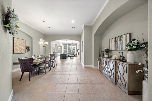 3822 Moreland Branch Ln, Katy, TX 77493 - dining area with arched walkways, light tile patterned flooring, crown molding, a chandelier, and recessed lighting