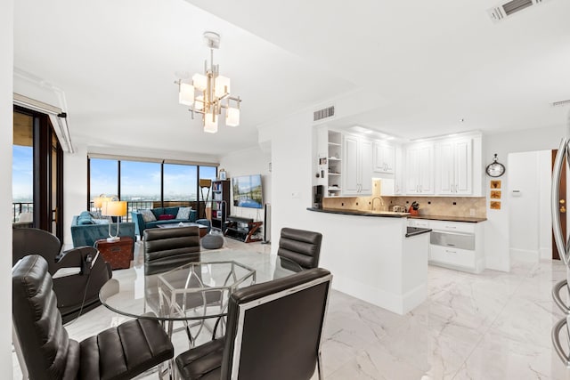 3350 Mccue Rd Unit 1901, Houston, TX 77056 - dining room with a chandelier and light marble finish floors