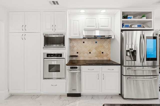 3350 Mccue Rd Unit 1901, Houston, TX 77056 - kitchen with appliances with stainless steel finishes, wall chimney exhaust hood, light marble finish flooring, and white cabinetry