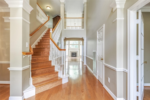 3718 W Pine Brook Way, Houston, TX 77059 - entrance foyer with decorative columns, wood finished floors, stairs, and a towering ceiling
