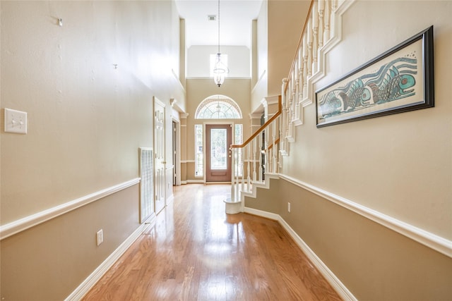 3718 W Pine Brook Way, Houston, TX 77059 - entryway featuring wood finished floors, a towering ceiling, stairway, and a chandelier