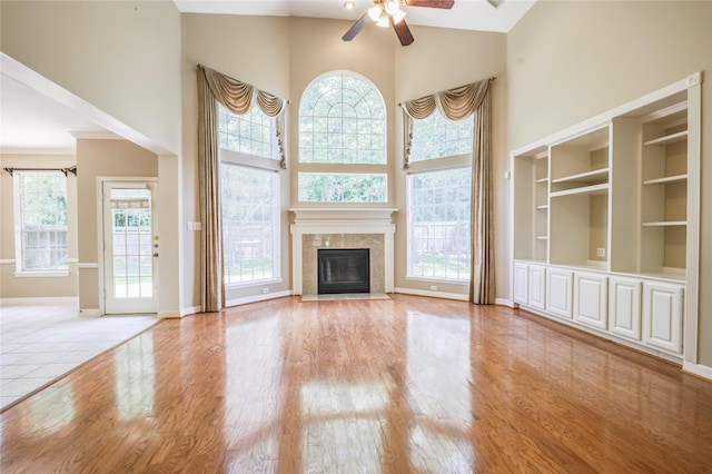3718 W Pine Brook Way, Houston, TX 77059 - unfurnished living room with a high ceiling, a ceiling fan, healthy amount of natural light, and wood finished floors