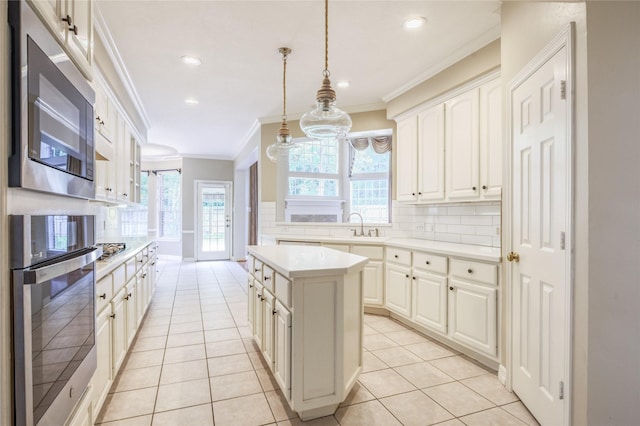 3718 W Pine Brook Way, Houston, TX 77059 - kitchen with stainless steel appliances, ornamental molding, backsplash, a kitchen island, and light countertops